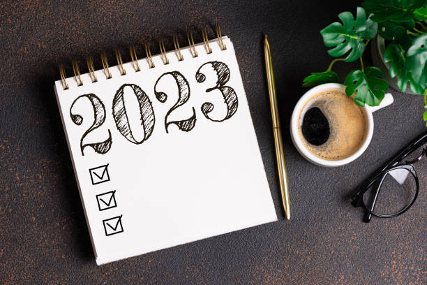 istock New year resolutions 2023 on desk. 2023 resolutions list with notebook, coffee cup on table. Goals, resolutions, plan, action, checklist concept. New Year 2023 background 1441419669