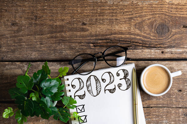 istock New year resolutions 2023 on desk. 2023 resolutions list with notebook, coffee cup on table. Goals, resolutions, plan, action, checklist concept. New Year 2023 background 1441419761