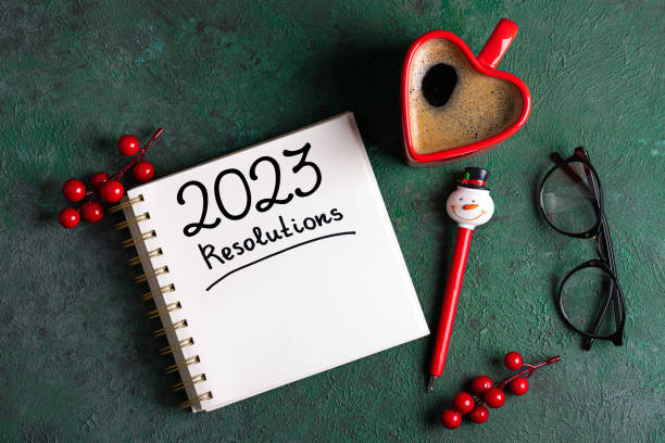 istock New year resolutions 2023 on desk. 2023 resolutions list with notebook, coffee cup, decorations on table. Goals, resolutions, plan, action concept. New Year 2023 background 1441419799
