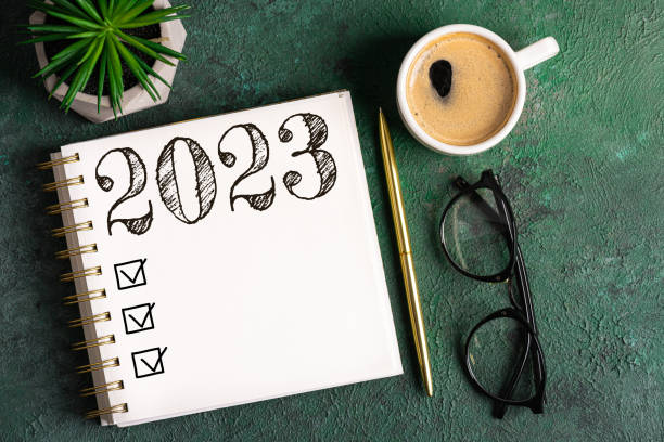 new year resolutions 2023 on desk. 2023 resolutions list with notebook, coffee cup on table. goals, resolutions, plan, action, checklist concept. new year 2023 background - determination new years eve list aspirations imagens e fotografias de stock