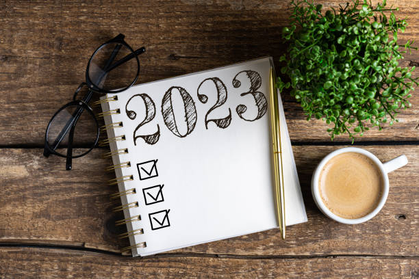 new year resolutions 2023 on desk. 2023 resolutions list with notebook, coffee cup on table. goals, resolutions, plan, action, checklist concept. new year 2023 background - determination new years eve list aspirations imagens e fotografias de stock