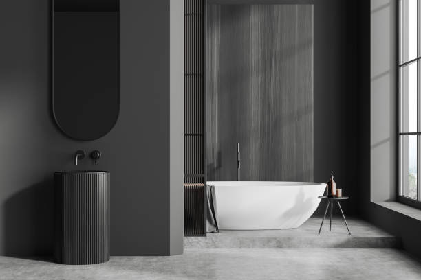 istock Grey bathroom interior with sink and tub near panoramic window 1441420615