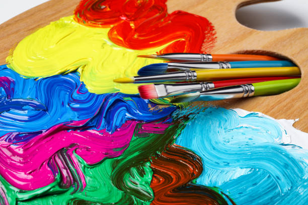 istock Palette with colorful acrylic paint and brushes on white background, closeup view 1441420855