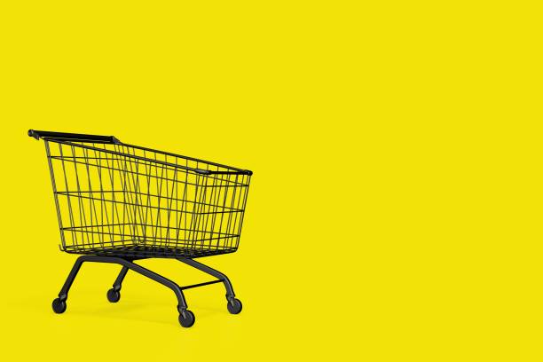 istock Shopping cart on yellow background, copy space. black friday concept 1441420886