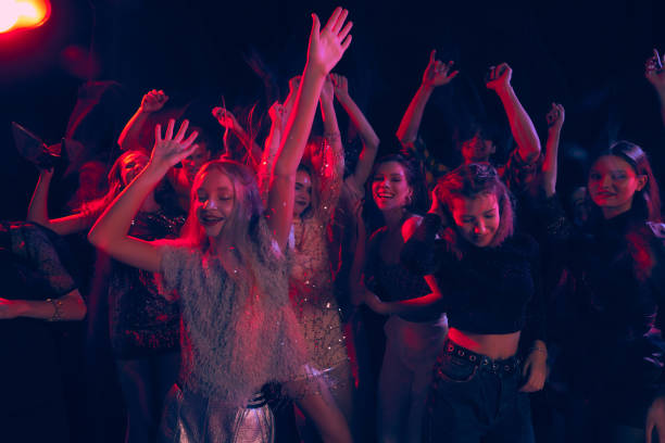 group of young people attending party, dancing, having fun over dark background in neon light. rock music festival - bar women silhouette child imagens e fotografias de stock