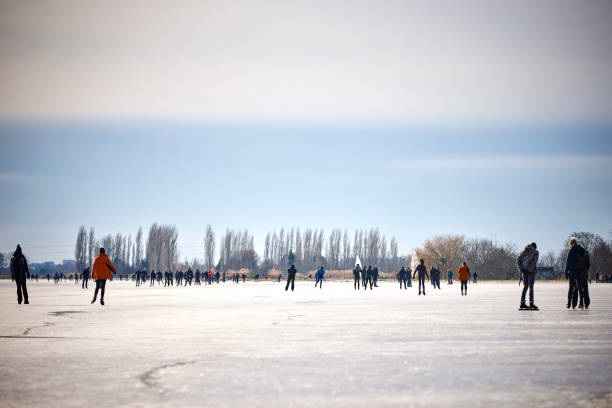 Ice skating on a frozen canal in the countryside in winter in the Netherlands