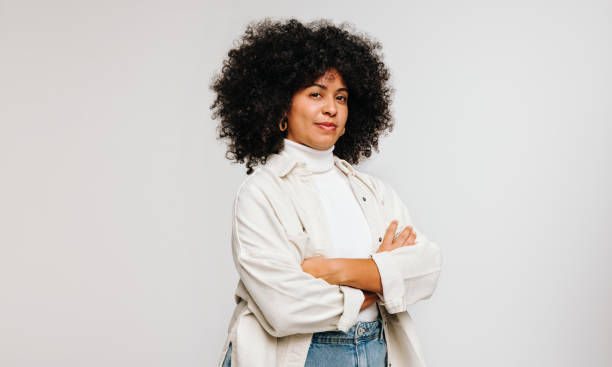 istock Confident woman with an Afro hairstyle standing in a studio 1441422753
