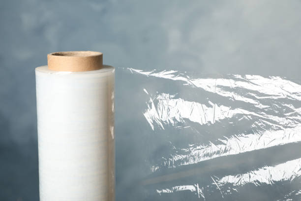 istock Roll of plastic stretch wrap film on blue background, closeup 1441424181