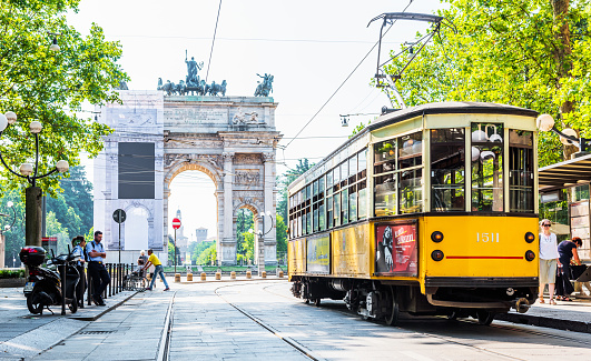 Milano, Italy - July 3, 2019: Arch of Peace (Arco della Pace) view with nostalgic yellow tram in Milano, Italy.