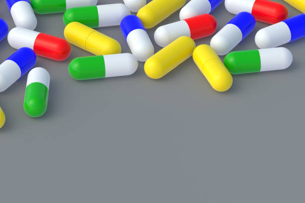 istock Lot of pills scattered on gray background. Copy space. 3d render 1441427149