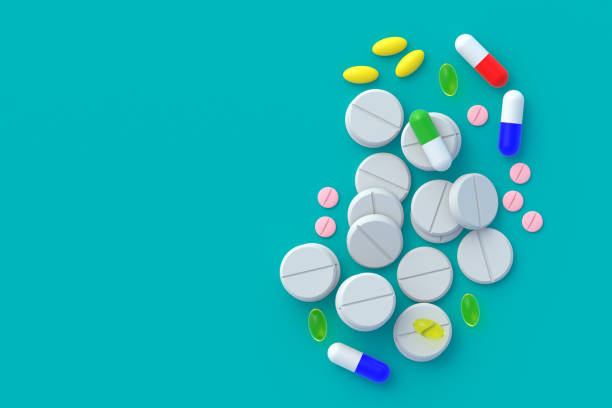 istock Pills scattered on turquoise background. Copy space. Top view. 3d render 1441427170