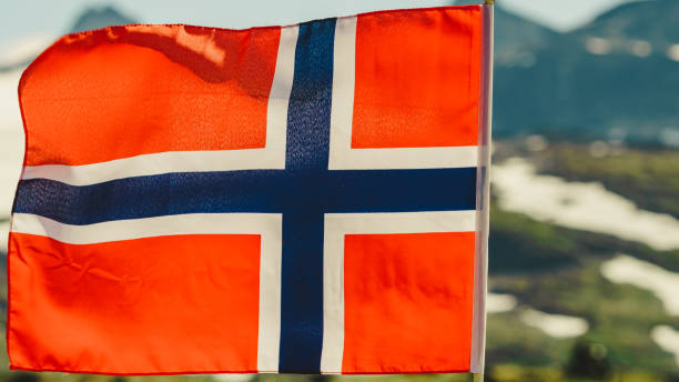 istock Norwegian flag and mountains snowy landscape 1441428761