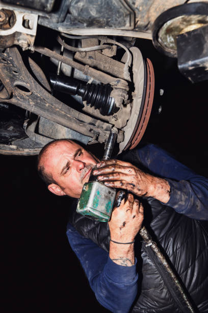 istock mechanical using impact screwdriver to fix car's drive shaft 1441428842