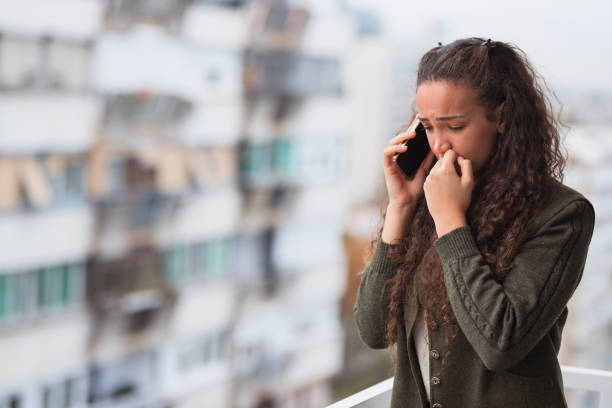 Sad business woman having phone conversation