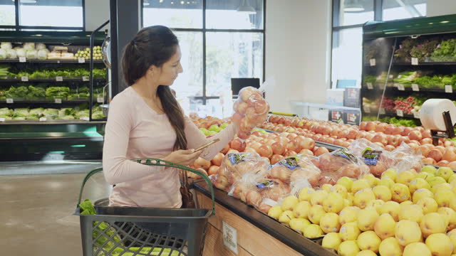 Personal shopper shops in produce section for customer