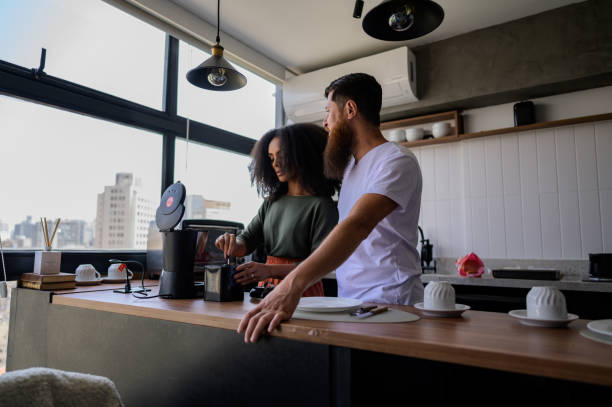 istock Couple preparing coffee and sandwiches together 1441432569