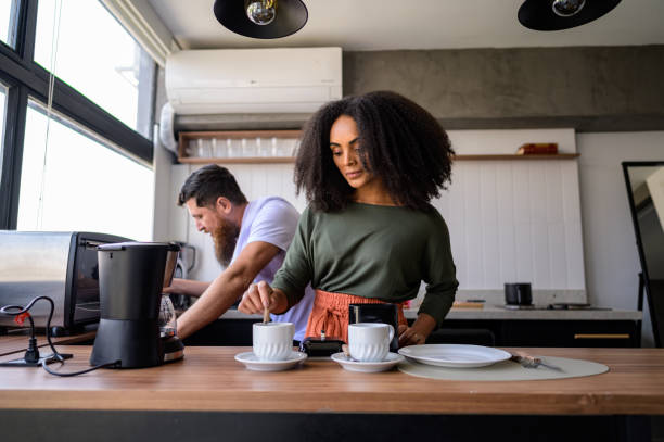 Couple preparing coffee and sandwiches together