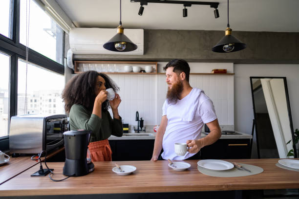 istock Couple drinking coffee in the kitchen 1441432625