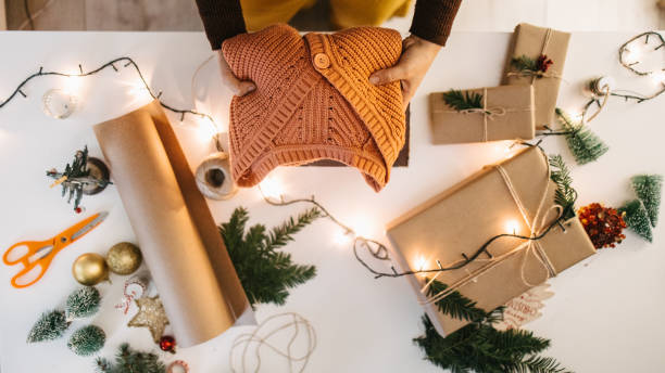 istock Woman packing sweater in a box for Christmas 1441432916