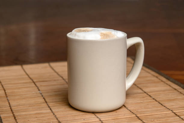 A cup of fresh coffee with cappuccino foam on the table
