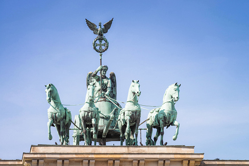 Front view close-up of the traditional quadriga statue on top of the Brandenburg Gate in Berlin's city centre.