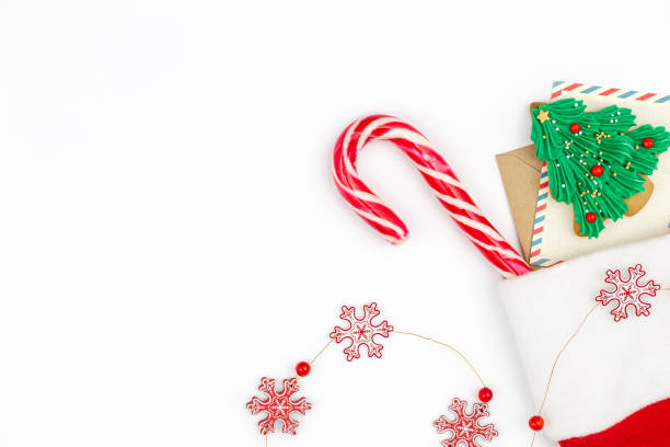 istock Christmas white background with Santa's sock with card, candy and gingerbread. 1441438418