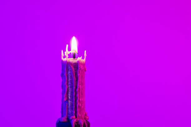 istock Texture vintage candle on a pink background with neon lighting, copy space. 1441438439
