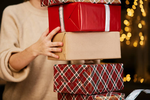 istock Woman holds pile og presents in gift box 1441439033