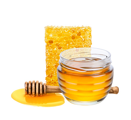 Honey isolated on white background. Jar with honey, honeycomb and honey dipper with drop of honey.