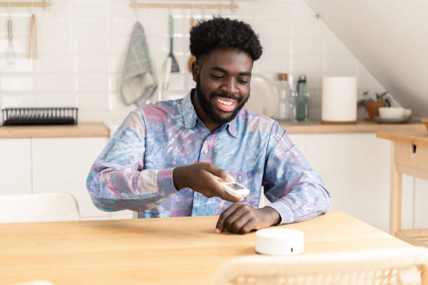 istock African American young man turning on smart system at his home 1441445509