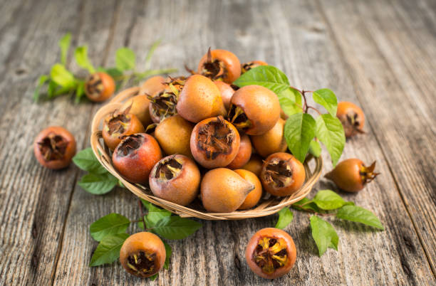 Fresh organic medlar on the wooden table