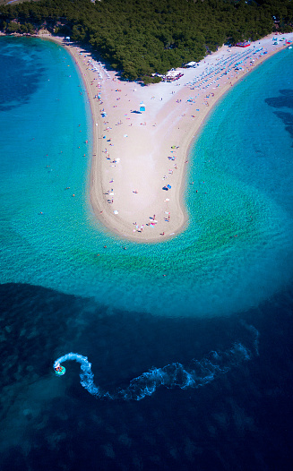 Dron view on Zlatni Rat - one of the most popular beachs in Croatia with characteristic shape. It changes its shape depending on sea currents.