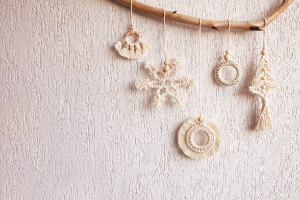 istock Christmas macrame decor. Christmas snowflake and decorative elements on wooden stick. Natural materials - cotton thread, wood beads. Eco decorations, ornaments, hand made decor. Copy space 1441447281