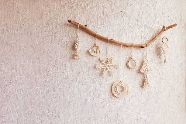istock Christmas macrame decor. Christmas snowflake and decorative elements on wooden stick. Natural materials - cotton thread, wood beads. Eco decorations, ornaments, hand made decor. Copy space 1441447292