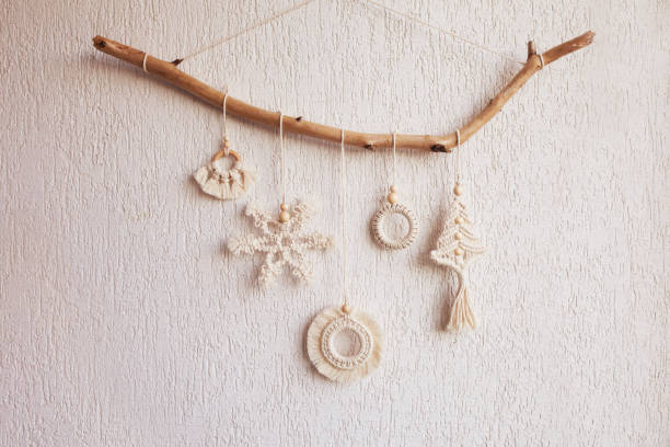 istock Christmas macrame decor. Christmas snowflake and decorative elements on wooden stick. Natural materials - cotton thread, wood beads. Eco decorations, ornaments, hand made decor. Copy space 1441447296