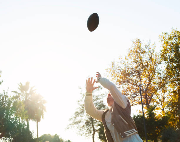 Young man jumping to catch the ball