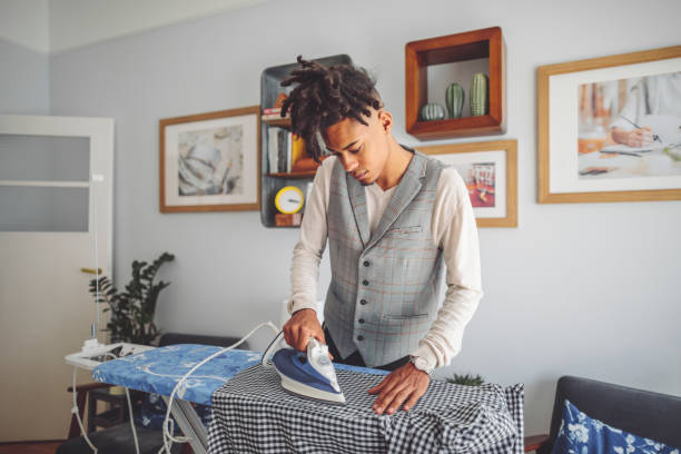 istock Young man ironing his shirt 1441449565