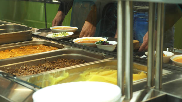 close-up, showcase with dishes in modern Self service canteen, cafeteria, mess hall, factory employees having lunch in the canteen, they are Served Meal In factory Canteen close-up, showcase with dishes in modern Self service canteen, cafeteria, mess hall, factory employees having lunch in the canteen, they are Served Meal In factory Canteen. High quality photo quick service restaurant cashier stock pictures, royalty-free photos & images
