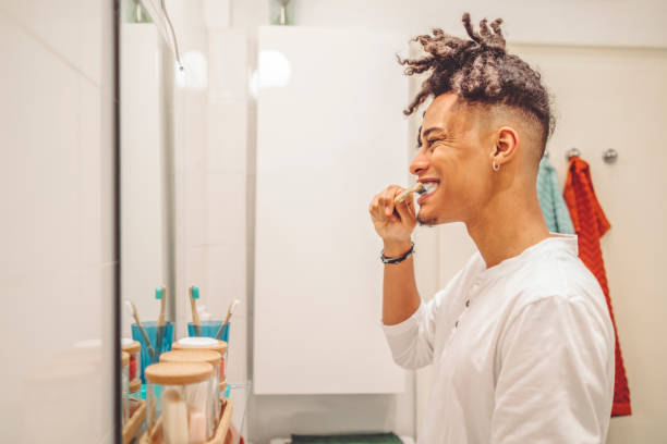 istock At home - young man brushing his teeth 1441453030