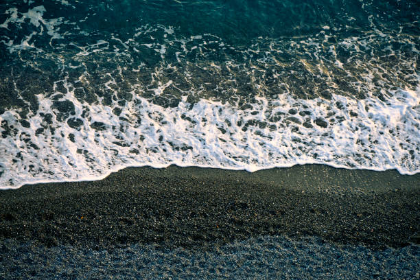 A beach of stones with sea waves