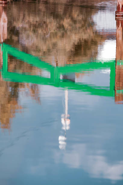 istock Reflection of green gate on water. 1441456871