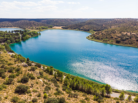 Natural Park of Lagunas de Ruidera in Spain. Panning shot through blue water