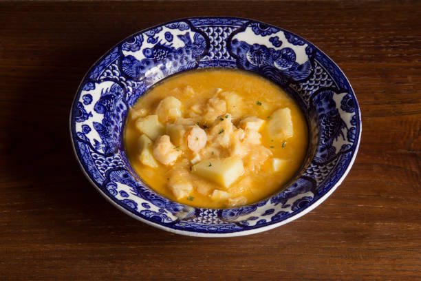 istock Presentation on a decorated plate of cooked cod and potatoes on a rustic chestnut wood background. 1441458527