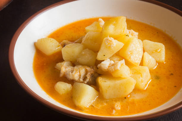 istock A plate of boiled potatoes with cod in a vegetable sauce on a dark wooden table. 1441458598
