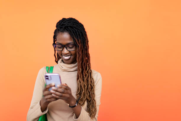 istock Studio Portrait of Young Black Woman with Mobile 1441460049
