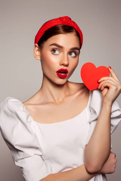 istock Beautiful emotional woman holding present box 1441463341