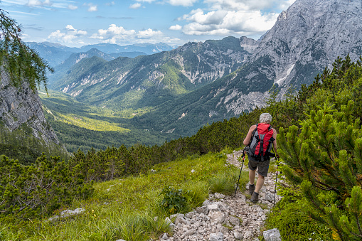 Senior men hiking in mountains in highlands of Triglav national park, Julian Alps