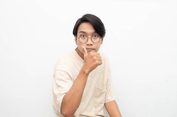 istock young asian man in beige tshirt gesturing thumbs up with happy expression 1441464185