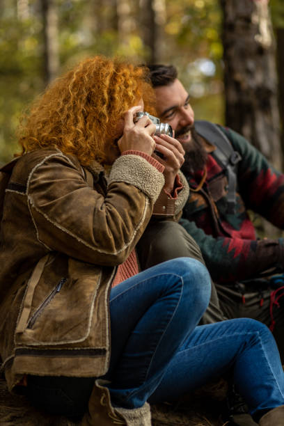 istock Young woman taking a photo with an old camera 1441465181