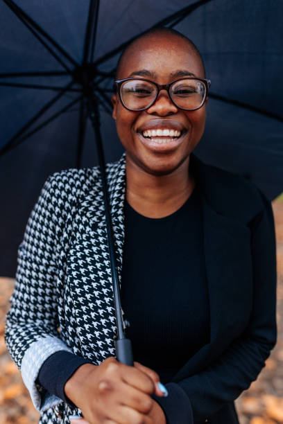 istock African American woman with umbrella. 1441466980